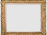 a gold framed mirror with ornate scrolls and scrolls on a white background