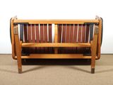 a wooden bench that is sitting in the middle of a room