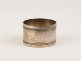 an antique silver napkin ring with engraved initials