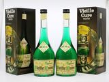 three bottles of green wine sitting next to each other on a table