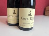 two bottles of wine that are sitting on a table
