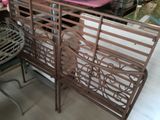 a metal bench with a pink cushion on top of it