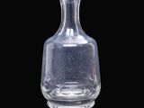 un vase en verre transparent posé sur une surface noire