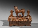 wooden sculpture of a dog and two birds on a table