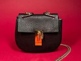 a black purse with a gold chain hanging from it