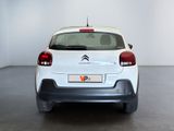 the rear end of a white citrole parked in a white room