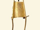 a gold bell hanging from the back of a chair