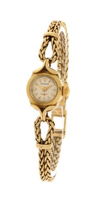 an image of a woman ' s wrist watch with a chain around it