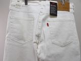 a pair of white jeans hanging on a hanger