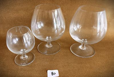 three empty wine glasses sitting next to each other on a table
