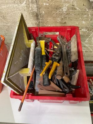 a red box filled with assorted tools on a table