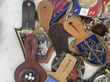 a lot of badges that are laying on a table