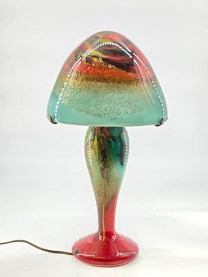 a colorful lamp that is sitting on a table