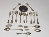 a lot of spoons and forks laid out on the table