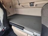 a seat in the back of a car with a laptop on it