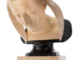 marble bust of a woman with a hat on top of it