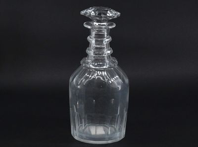 a clear glass bottle with a stopper on top of it