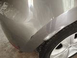 a close up of a car ' s front bumper and tire