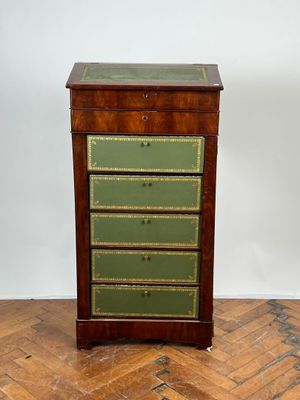 une commode ancienne en bois dont les tiroirs sont peints en vert