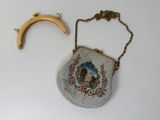 a small purse with a gold handle and a small purse with a gold handle