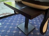a black table with a bowl on it and a mirror on the table