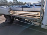 a white truck with a flat bed in a parking lot