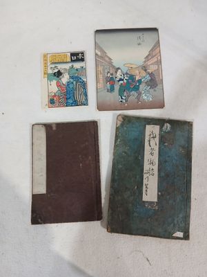 three old books sitting on top of a table next to each other