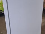 a white refrigerator that is sitting in a warehouse