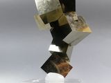 sculpture made of metal blocks on a clear base on a gray background