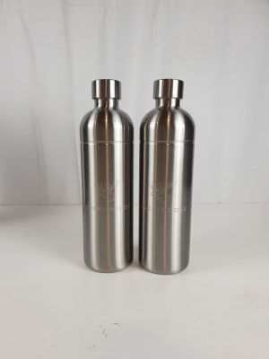 two stainless steel water bottles sitting on a white surface