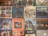 a lot of records on the wall of a room