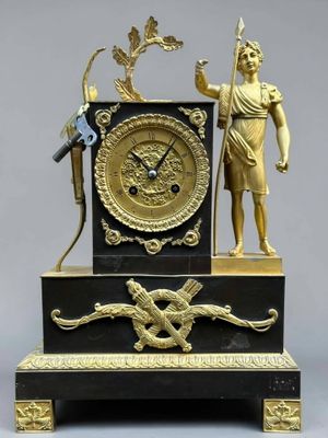 a statue of a man holding a sword and a clock on a table