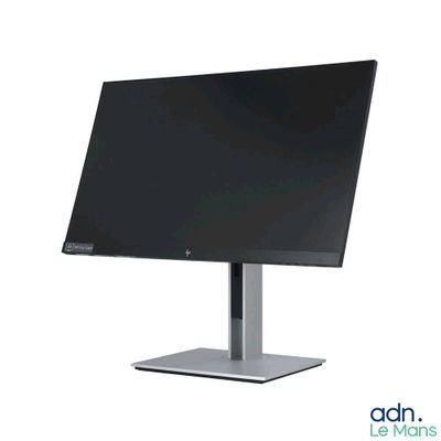 the monitor is sitting on a metal stand on a white surface