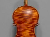 an old violin with a wooden back and a wooden bow
