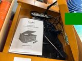 a table with a book on it and a cell phone in a box