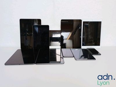 several cell phones are lined up on a table with a white background