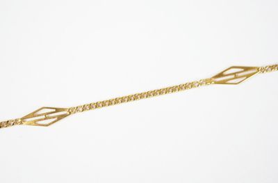 a close up of a gold bracelet on a white background