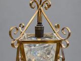 a close up of a light fixture hanging from a chain