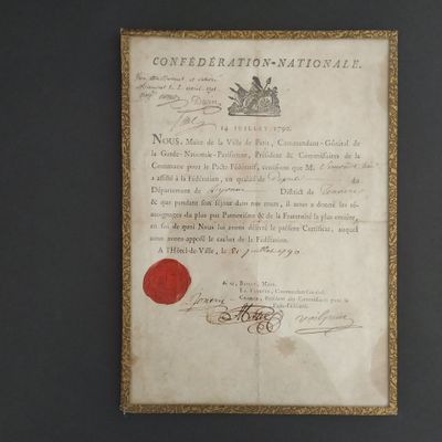 an old document with a red wax seal on it sitting on a table
