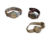 three different types of watches are displayed on a white surface
