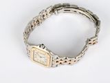 an image of a silver and gold wrist watch on a white surface