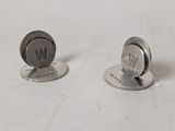 pair of silver plated cufflinks with initials on them on a white surface