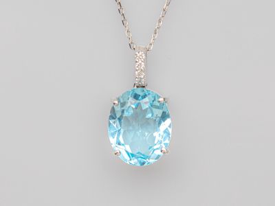a blue topaz quartz and diamond pendant on a chain