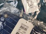 a lot of clothes that are wrapped in plastic bags