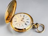 an old gold pocket watch with roman numerals and a chain