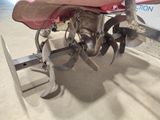 a small propeller attached to a small boat in a garage