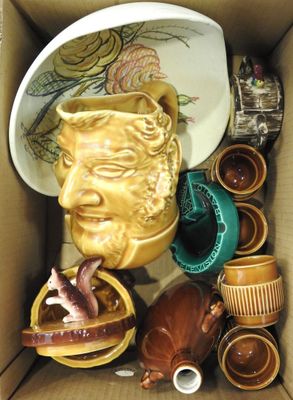 a cardboard box with a lot of pottery items in it