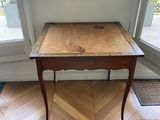 a small wooden table with a drawer on top of it