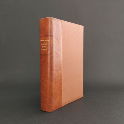 a brown book sitting on top of a table next to a gray wall