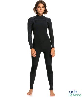 a woman in a black wetsuit standing on a white background